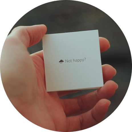 holding card that reads 'not happy'